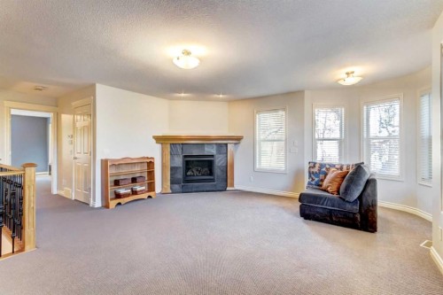 236 Somme Avenue Sw, Calgary, AB - Indoor Photo Showing Living Room With Fireplace