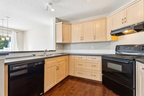 73 Rocky Ridge Heath Nw, Calgary, AB - Indoor Photo Showing Kitchen With Double Sink