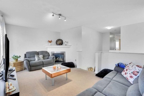 73 Covebrook Place Ne, Calgary, AB - Indoor Photo Showing Living Room With Fireplace