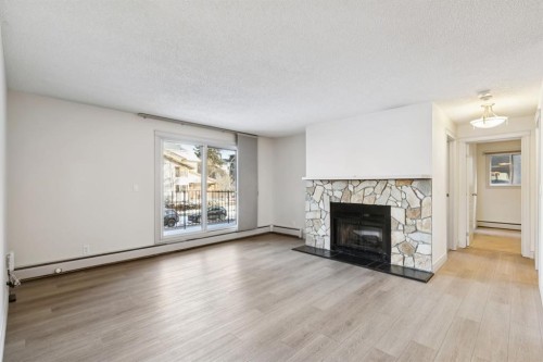 6-1607 26 Avenue Sw, Calgary, AB - Indoor Photo Showing Living Room With Fireplace