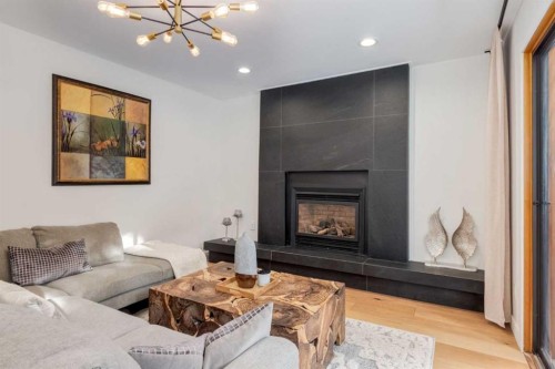 113 Straddock Terrace Sw, Calgary, AB - Indoor Photo Showing Living Room With Fireplace