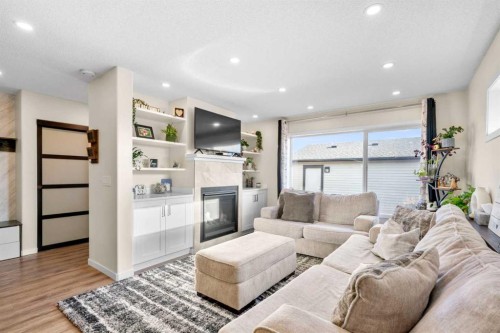 17 Cranford Place Se, Calgary, AB - Indoor Photo Showing Living Room With Fireplace