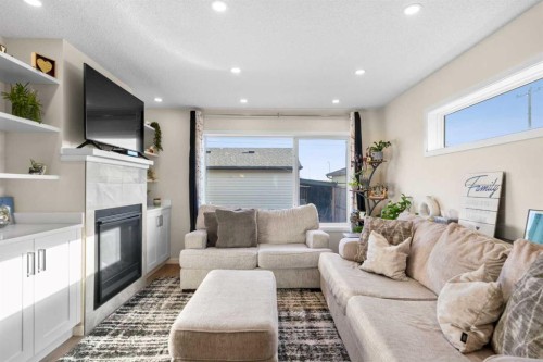 17 Cranford Place Se, Calgary, AB - Indoor Photo Showing Living Room With Fireplace