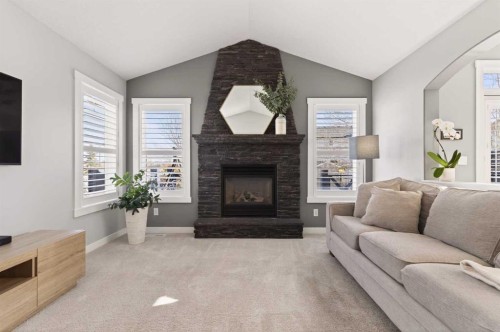 4 Cougarstone Square Sw, Calgary, AB - Indoor Photo Showing Living Room With Fireplace