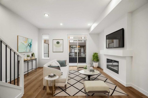 202-550 Seton Circle Se, Calgary, AB - Indoor Photo Showing Living Room With Fireplace