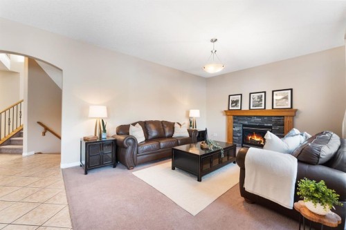 8 Heritage Cove, Heritage Pointe, AB - Indoor Photo Showing Living Room With Fireplace
