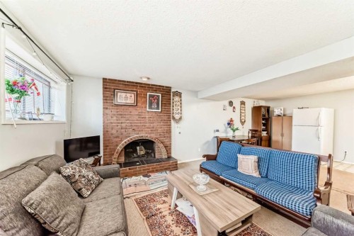 7160 Temple Drive Ne, Calgary, AB - Indoor Photo Showing Living Room With Fireplace
