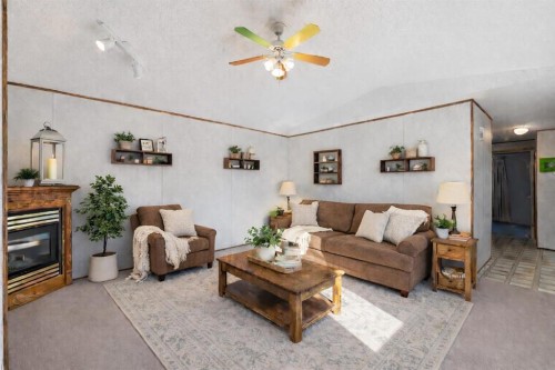 1909 29 Avenue, Nanton, AB - Indoor Photo Showing Living Room With Fireplace