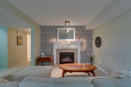 271 Tuscany Valley Drive Nw, Calgary, AB - Indoor Photo Showing Living Room With Fireplace