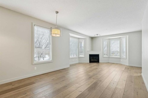 202-880 Centre Avenue Ne, Calgary, AB - Indoor Photo Showing Living Room With Fireplace