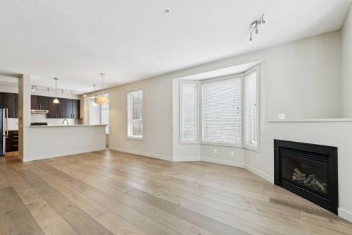 202-880 Centre Avenue Ne, Calgary, AB - Indoor Photo Showing Living Room With Fireplace