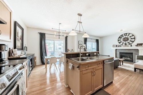 936 Copperfield Boulevard Se, Calgary, AB - Indoor Photo Showing Kitchen With Fireplace With Double Sink