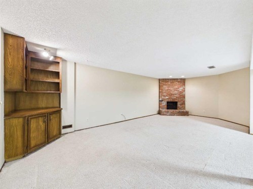 503 Dalcastle Mews Nw, Calgary, AB - Indoor Photo Showing Other Room With Fireplace