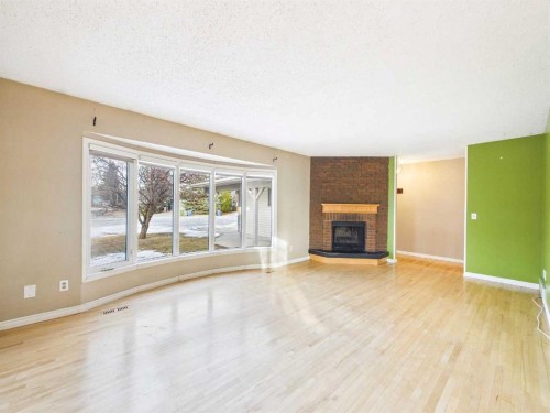 503 Dalcastle Mews Nw, Calgary, AB - Indoor Photo Showing Living Room With Fireplace