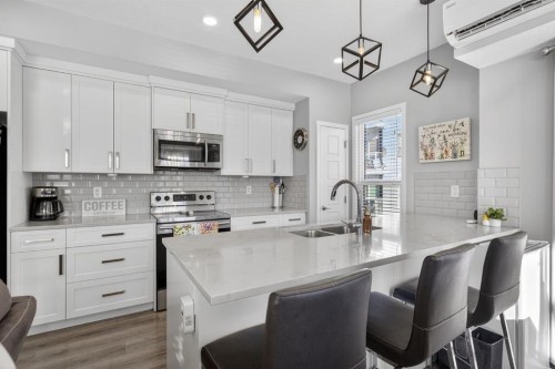 204-4150 Seton Drive Se, Calgary, AB - Indoor Photo Showing Kitchen With Double Sink With Upgraded Kitchen