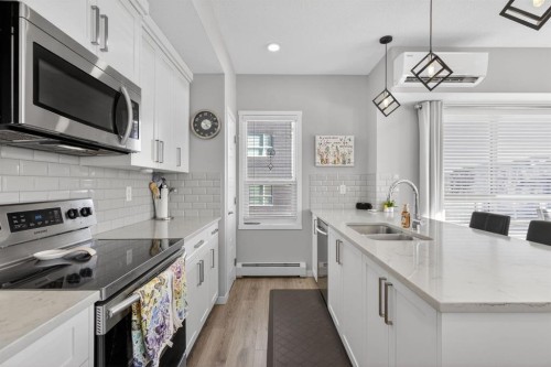 204-4150 Seton Drive Se, Calgary, AB - Indoor Photo Showing Kitchen With Stainless Steel Kitchen With Double Sink With Upgraded Kitchen
