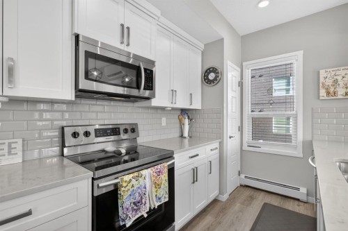 204-4150 Seton Drive Se, Calgary, AB - Indoor Photo Showing Kitchen With Stainless Steel Kitchen With Upgraded Kitchen