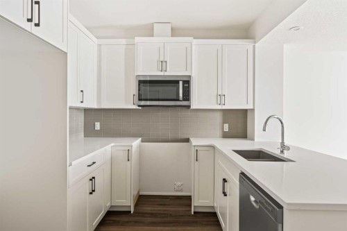 27 Setonvista Grove Se, Calgary, AB - Indoor Photo Showing Kitchen With Double Sink