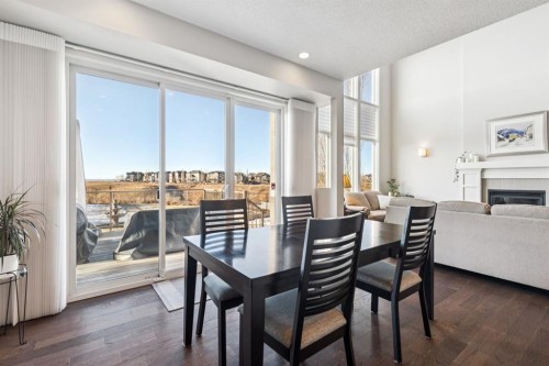 101 Cranarch Common Se, Calgary, AB - Indoor Photo Showing Dining Room With Fireplace