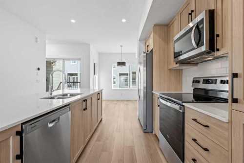 1007-25 Wildwoods Court Sw, Airdrie, AB - Indoor Photo Showing Kitchen With Stainless Steel Kitchen With Double Sink With Upgraded Kitchen