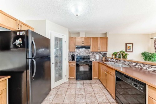 116 Hidden Creek Rise Nw, Calgary, AB - Indoor Photo Showing Kitchen With Double Sink
