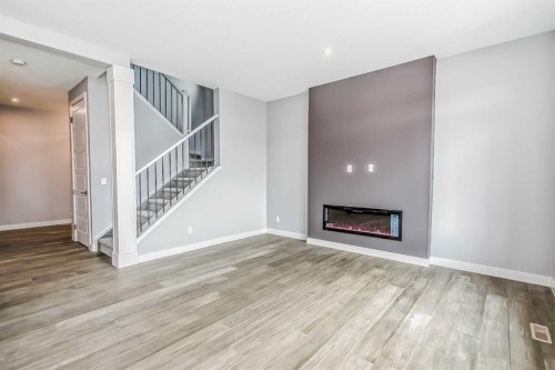 4 Topaz Place, Cochrane, AB - Indoor Photo Showing Living Room With Fireplace