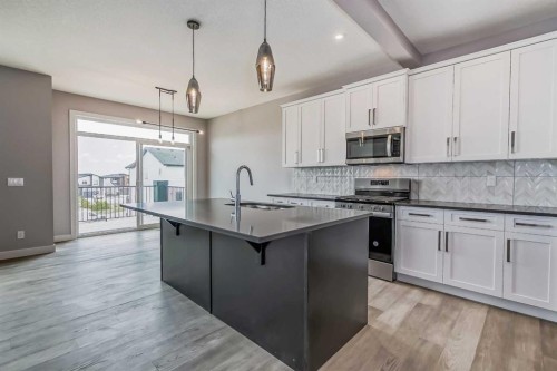 4 Topaz Place, Cochrane, AB - Indoor Photo Showing Kitchen With Upgraded Kitchen