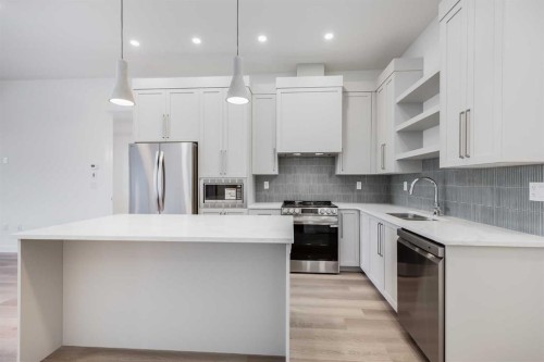 1414-520 Reynolds Avenue Sw, Airdrie, AB - Indoor Photo Showing Kitchen With Upgraded Kitchen