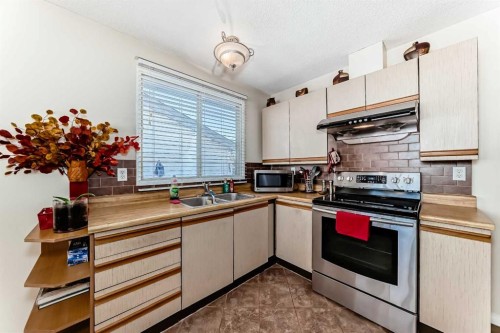 208 Bracewood Road Sw, Calgary, AB - Indoor Photo Showing Kitchen With Double Sink