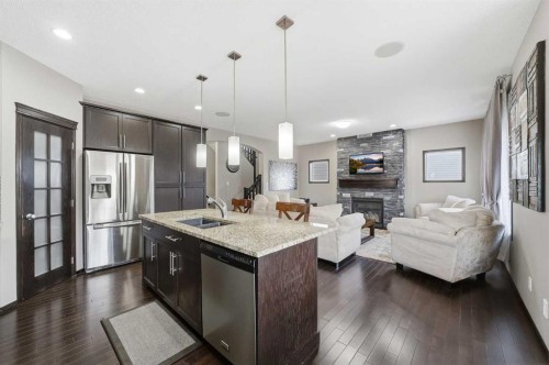 65 Elgin Meadows Circle Se, Calgary, AB - Indoor Photo Showing Kitchen With Fireplace With Stainless Steel Kitchen With Double Sink With Upgraded Kitchen