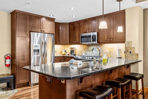 112-379 Spring Creek Drive, Canmore, AB - Indoor Photo Showing Kitchen With Upgraded Kitchen