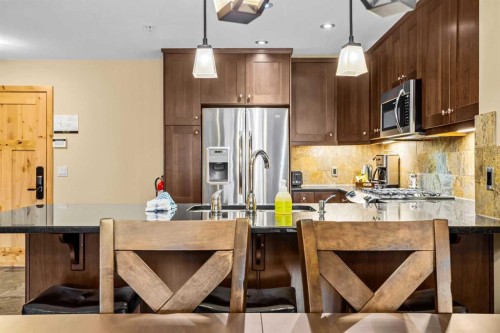 112-379 Spring Creek Drive, Canmore, AB - Indoor Photo Showing Kitchen With Upgraded Kitchen
