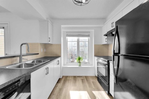 169 Windstone Park Sw, Airdrie, AB - Indoor Photo Showing Kitchen With Double Sink