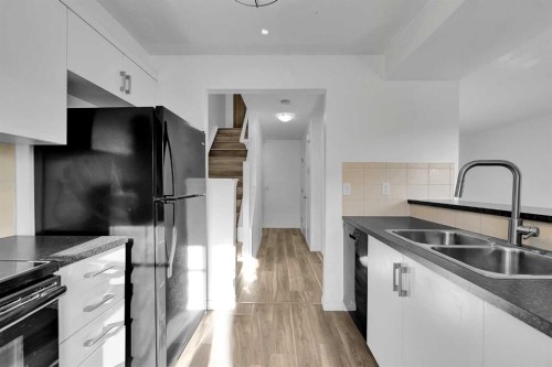 169 Windstone Park Sw, Airdrie, AB - Indoor Photo Showing Kitchen With Double Sink