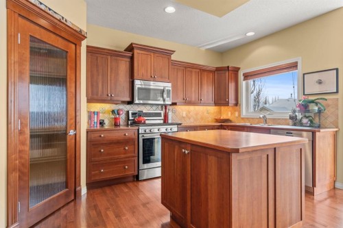 153 Crestridge Way Sw, Calgary, AB - Indoor Photo Showing Kitchen With Double Sink