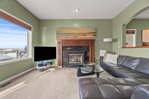 153 Crestridge Way Sw, Calgary, AB - Indoor Photo Showing Living Room With Fireplace
