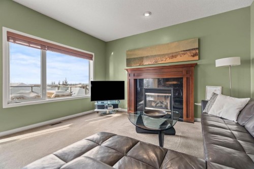 153 Crestridge Way Sw, Calgary, AB - Indoor Photo Showing Living Room With Fireplace