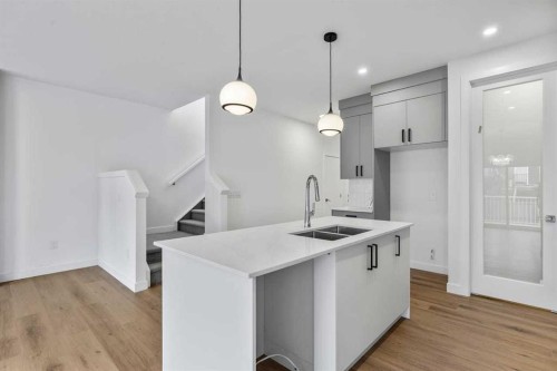 90 Heritage Circle, Cochrane, AB - Indoor Photo Showing Kitchen With Double Sink With Upgraded Kitchen