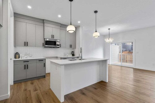 90 Heritage Circle, Cochrane, AB - Indoor Photo Showing Kitchen With Upgraded Kitchen