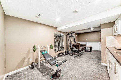 707 Malvern Drive Ne, Calgary, AB - Indoor Photo Showing Gym Room