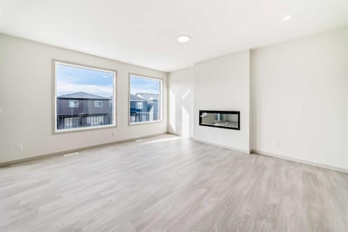 31 Lucas Passage Nw, Calgary, AB - Indoor Photo Showing Living Room With Fireplace