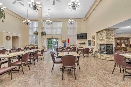 3340-6818 Pinecliff Grove Ne, Calgary, AB - Indoor Photo Showing Dining Room With Fireplace