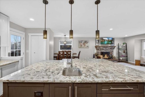 102 Hodson Crescent, Okotoks, AB - Indoor Photo Showing Kitchen With Upgraded Kitchen