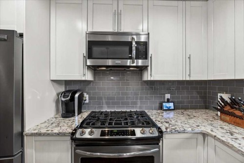 102 Hodson Crescent, Okotoks, AB - Indoor Photo Showing Kitchen With Upgraded Kitchen