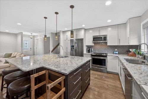 102 Hodson Crescent, Okotoks, AB - Indoor Photo Showing Kitchen With Double Sink With Upgraded Kitchen