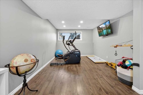 102 Hodson Crescent, Okotoks, AB - Indoor Photo Showing Gym Room