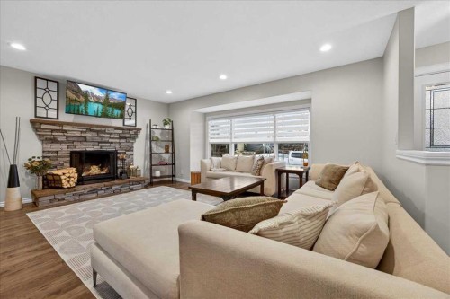 102 Hodson Crescent, Okotoks, AB - Indoor Photo Showing Living Room With Fireplace