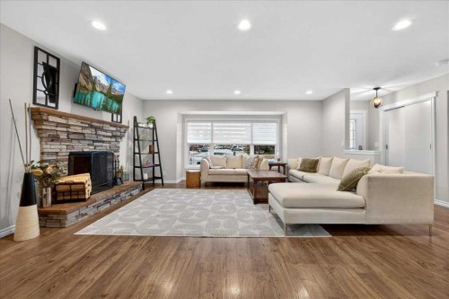 102 Hodson Crescent, Okotoks, AB - Indoor Photo Showing Living Room With Fireplace