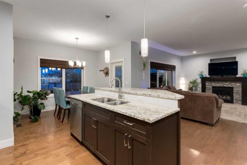 2050 High Country Rise, High River, AB - Indoor Photo Showing Kitchen With Fireplace With Double Sink