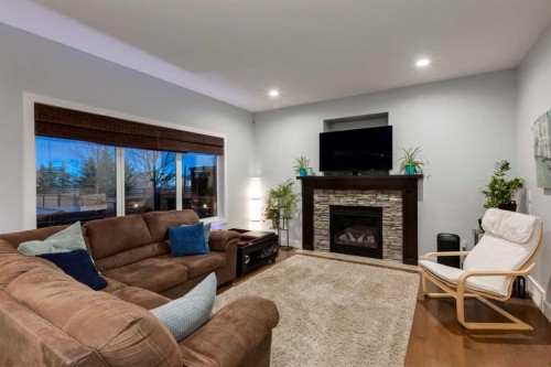 2050 High Country Rise, High River, AB - Indoor Photo Showing Living Room With Fireplace